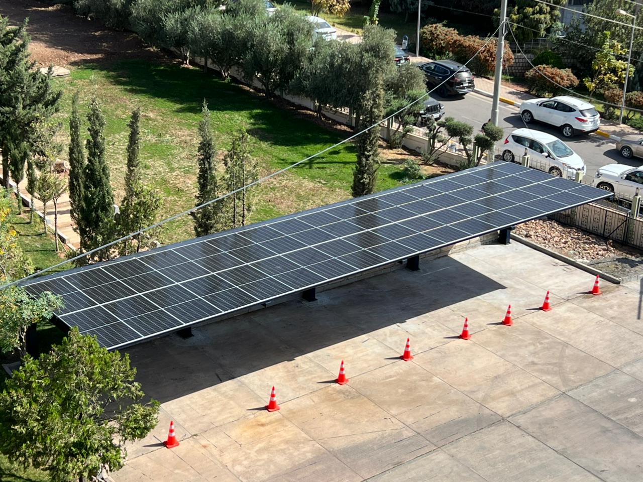 Koya University solar carport array beside campus access road
